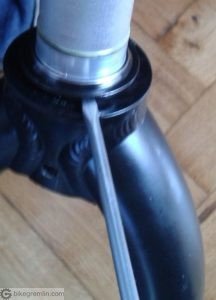 Placing a flat bladed screwdriver between the crown and the cone, gently twisting the screwdriver<br /> Apologies for the poor image quality